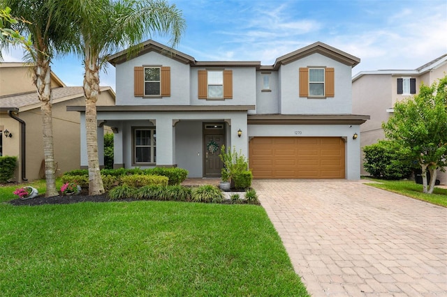 1270 Fountain Coin Loop, Orlando, FL 32828 - view of front of property featuring stucco siding, decorative driveway, a front yard, a garage, and a porch
