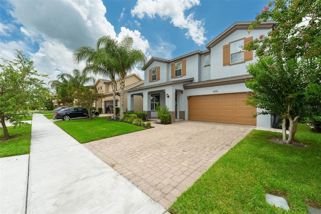 1270 Fountain Coin Loop, Orlando, FL 32828 - view of front of home with a garage, decorative driveway, stucco siding, and a front lawn