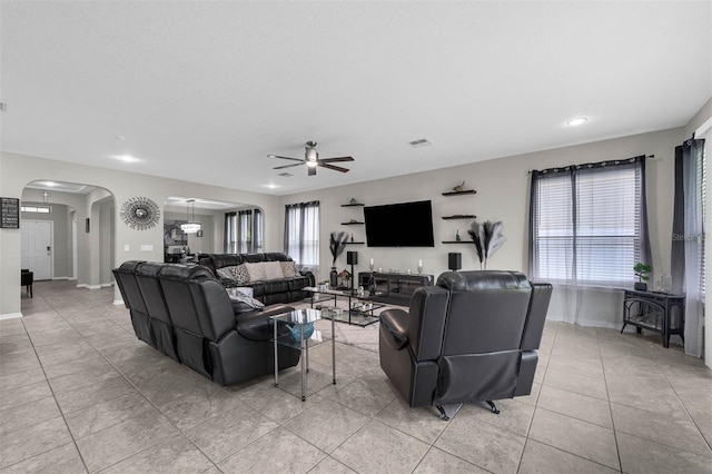 1270 Fountain Coin Loop, Orlando, FL 32828 - living room featuring arched walkways, ceiling fan, light tile patterned flooring, and recessed lighting
