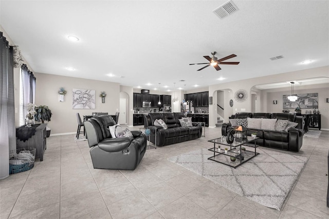 1270 Fountain Coin Loop, Orlando, FL 32828 - living room featuring arched walkways, a ceiling fan, recessed lighting, and light tile patterned floors
