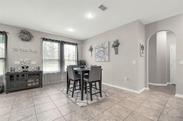 1270 Fountain Coin Loop, Orlando, FL 32828 - dining room featuring arched walkways, light tile patterned floors, and recessed lighting