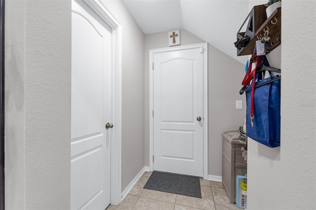 1270 Fountain Coin Loop, Orlando, FL 32828 - doorway with vaulted ceiling, a textured ceiling, and light tile patterned flooring