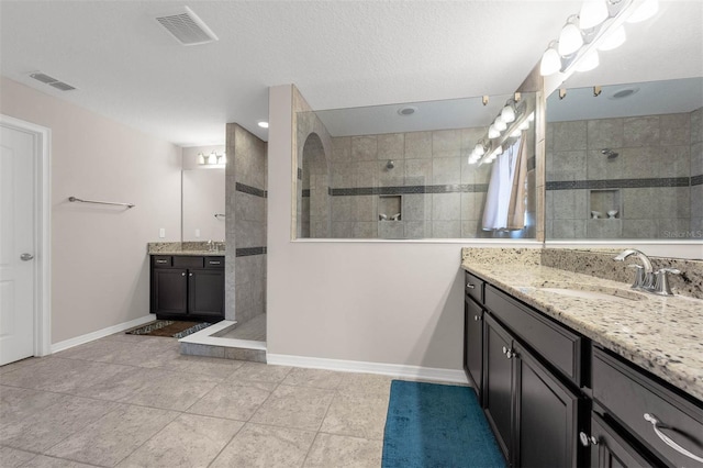1270 Fountain Coin Loop, Orlando, FL 32828 - bathroom featuring a walk in shower, two vanities, and tile patterned floors