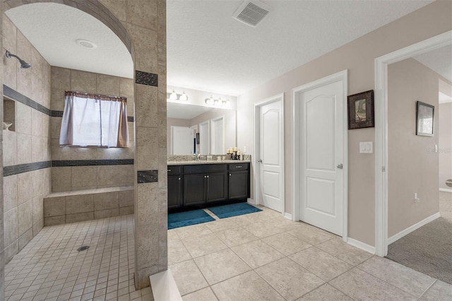 1270 Fountain Coin Loop, Orlando, FL 32828 - bathroom with vanity, tiled shower, and tile patterned floors