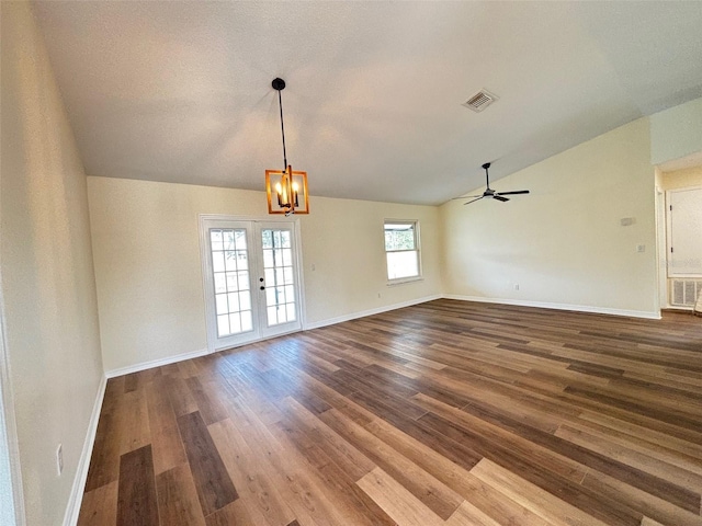3055 Kirkland St, Deltona, FL 32738 - unfurnished room featuring vaulted ceiling, wood finished floors, a chandelier, and a ceiling fan