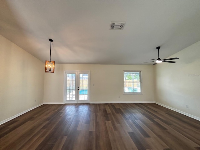 3055 Kirkland St, Deltona, FL 32738 - spare room with lofted ceiling, dark wood finished floors, a chandelier, a ceiling fan, and french doors