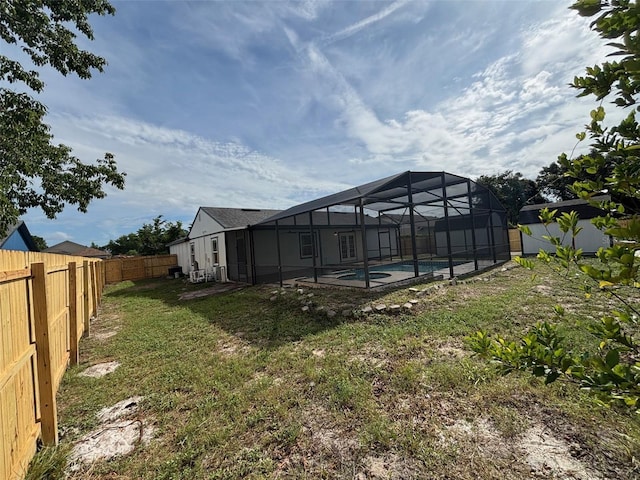 3055 Kirkland St, Deltona, FL 32738 - rear view of property featuring a fenced backyard, a lanai, and a pool with connected hot tub