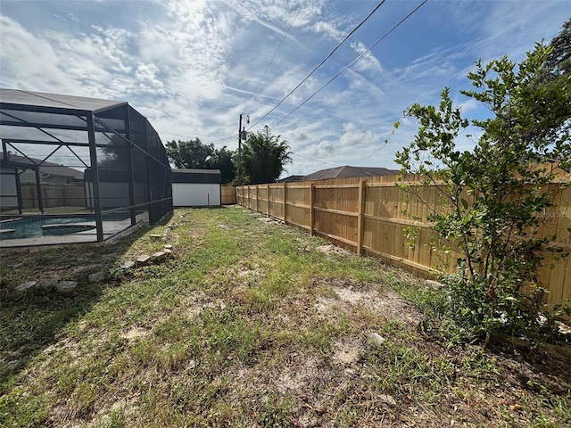 3055 Kirkland St, Deltona, FL 32738 - fenced backyard with a storage unit and a lanai