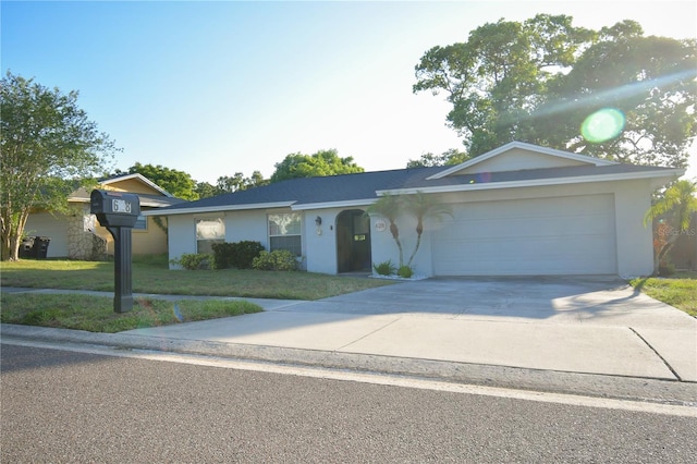 628 Riverview Ave, Altamonte Springs, FL 32714 - view of front of house with a front yard, a garage, driveway, and stucco siding