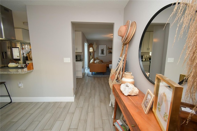 628 Riverview Ave, Altamonte Springs, FL 32714 - hallway with light wood-style flooring and arched walkways
