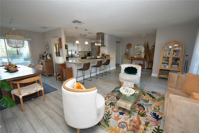 628 Riverview Ave, Altamonte Springs, FL 32714 - living area with a textured ceiling and light wood finished floors