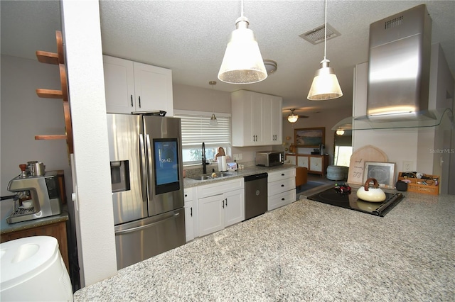 628 Riverview Ave, Altamonte Springs, FL 32714 - kitchen featuring appliances with stainless steel finishes, exhaust hood, white cabinets, decorative light fixtures, and light stone countertops