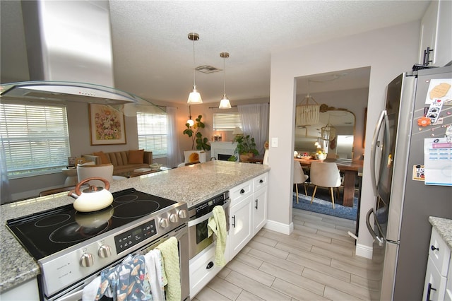 628 Riverview Ave, Altamonte Springs, FL 32714 - kitchen featuring appliances with stainless steel finishes, island range hood, white cabinets, hanging light fixtures, and light stone countertops