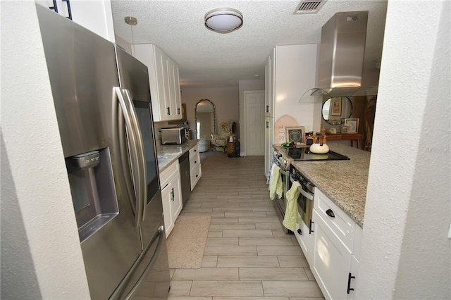 628 Riverview Ave, Altamonte Springs, FL 32714 - kitchen with appliances with stainless steel finishes, wall chimney range hood, white cabinetry, light stone countertops, and a textured ceiling