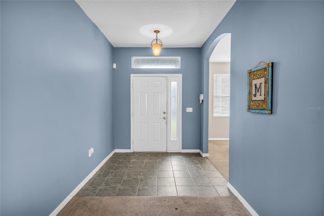 209 Grouper Ct, Poinciana, FL 34759 - entrance foyer featuring arched walkways and tile patterned floors