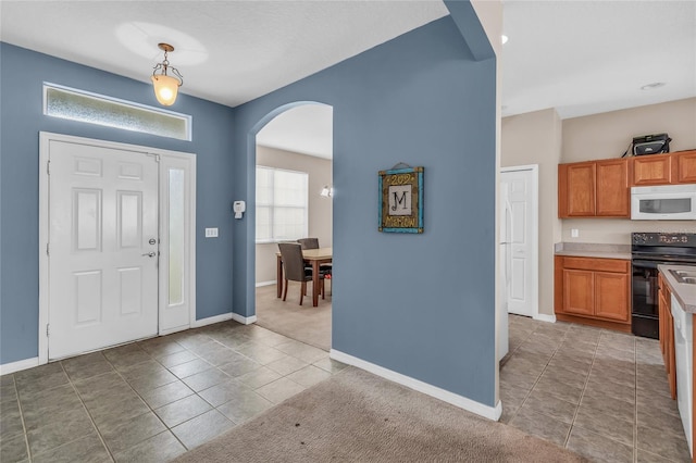 209 Grouper Ct, Poinciana, FL 34759 - foyer featuring arched walkways and light tile patterned floors