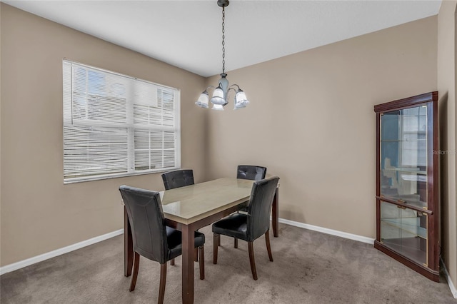 209 Grouper Ct, Poinciana, FL 34759 - carpeted dining space with a chandelier and baseboards