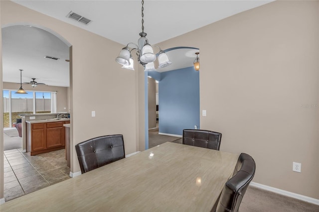 209 Grouper Ct, Poinciana, FL 34759 - unfurnished dining area with arched walkways, a chandelier, and ceiling fan