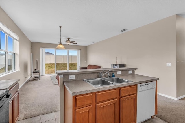 209 Grouper Ct, Poinciana, FL 34759 - kitchen with white dishwasher, light colored carpet, ceiling fan, open floor plan, and range with electric stovetop