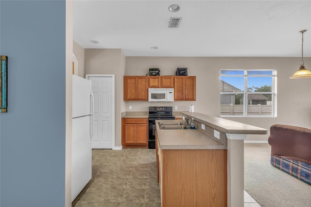 209 Grouper Ct, Poinciana, FL 34759 - kitchen with white appliances, brown cabinetry, pendant lighting, light countertops, and recessed lighting