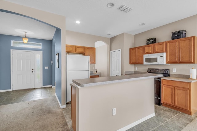 209 Grouper Ct, Poinciana, FL 34759 - kitchen featuring white appliances, light tile patterned floors, arched walkways, light countertops, and a kitchen island