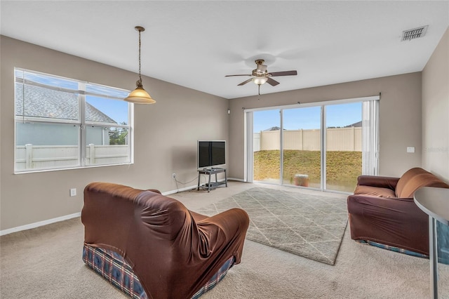 209 Grouper Ct, Poinciana, FL 34759 - carpeted living room featuring ceiling fan and baseboards