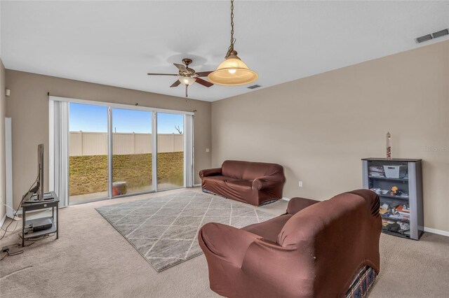 209 Grouper Ct, Poinciana, FL 34759 - carpeted living area with a ceiling fan and baseboards