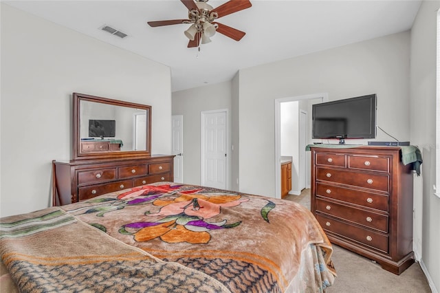 209 Grouper Ct, Poinciana, FL 34759 - bedroom with light colored carpet, ensuite bathroom, and ceiling fan