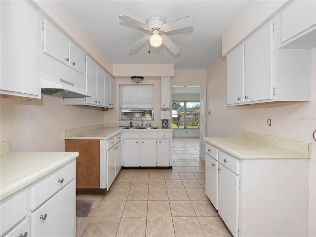 1432 Findlay St, Deltona, FL 32725 - kitchen with ceiling fan, light countertops, and white cabinetry
