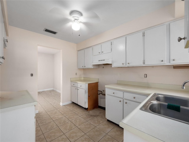 1432 Findlay St, Deltona, FL 32725 - kitchen with custom range hood, ceiling fan, light tile patterned floors, white cabinets, and light countertops