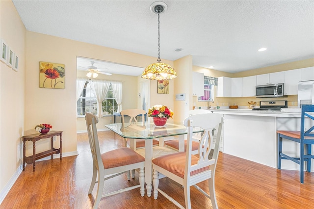 8076 SE 174th Belhaven Loop, The Villages, FL 32162 - dining area featuring light wood-style floors, a textured ceiling, and recessed lighting