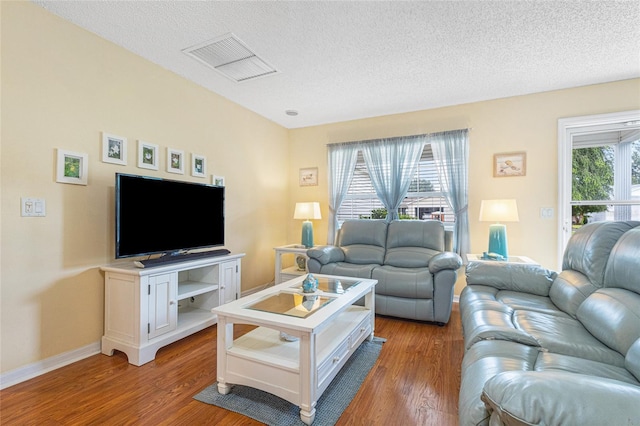 8076 SE 174th Belhaven Loop, The Villages, FL 32162 - living area with wood finished floors and a textured ceiling