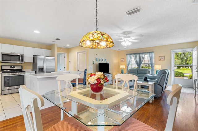 8076 SE 174th Belhaven Loop, The Villages, FL 32162 - dining space with light wood-type flooring, a ceiling fan, a textured ceiling, and recessed lighting