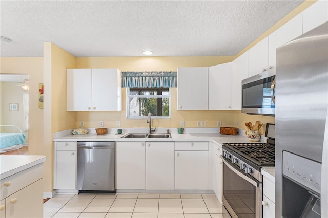 8076 SE 174th Belhaven Loop, The Villages, FL 32162 - kitchen featuring stainless steel appliances, light countertops, a textured ceiling, white cabinets, and recessed lighting