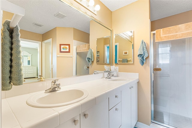 8076 SE 174th Belhaven Loop, The Villages, FL 32162 - full bath featuring double vanity, a stall shower, and a textured ceiling