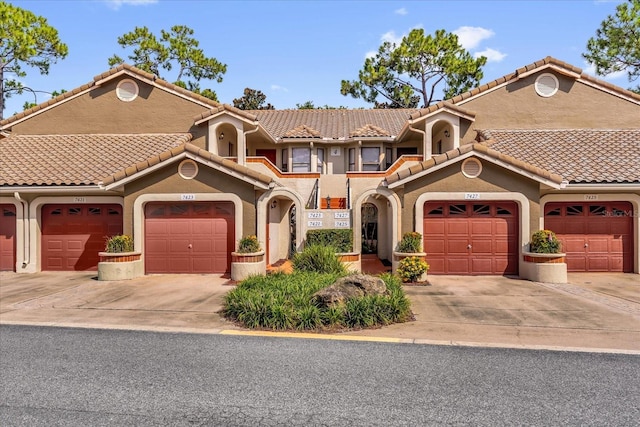 7421 Sugar Bend Dr Unit 7421, Orlando, FL 32819 - view of front of home with stucco siding and a tiled roof
