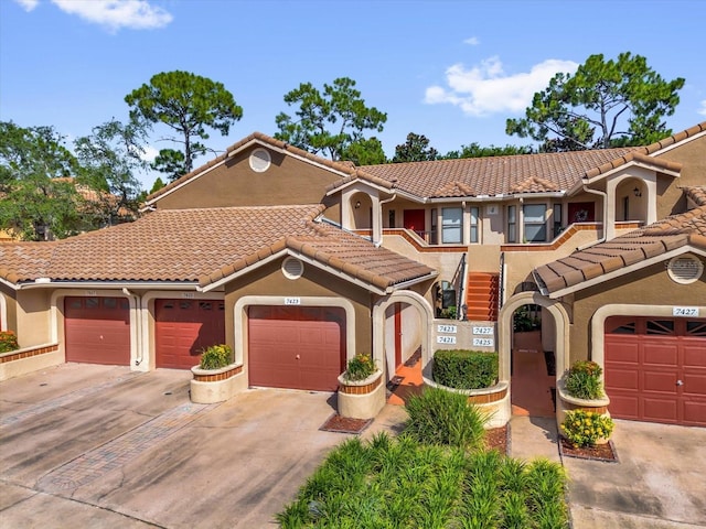 7421 Sugar Bend Dr Unit 7421, Orlando, FL 32819 - view of front of home featuring stucco siding, a tiled roof, and concrete driveway