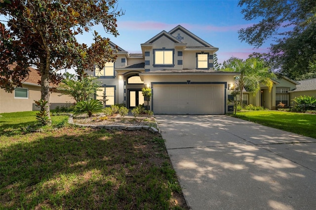 7716 Nottinghill Sky Dr, Apollo Beach, FL 33572 - view of front of house featuring stucco siding, driveway, an attached garage, and a lawn