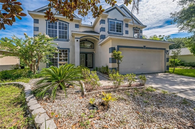 7716 Nottinghill Sky Dr, Apollo Beach, FL 33572 - traditional-style home with french doors, stucco siding, concrete driveway, and a garage