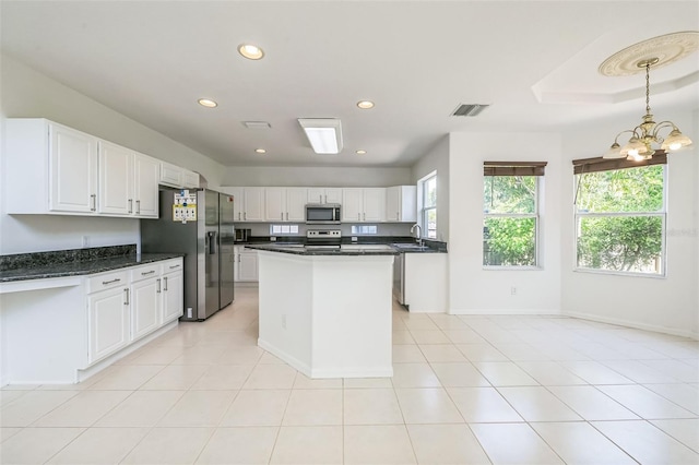 7716 Nottinghill Sky Dr, Apollo Beach, FL 33572 - kitchen featuring appliances with stainless steel finishes, plenty of natural light, white cabinetry, a chandelier, and recessed lighting