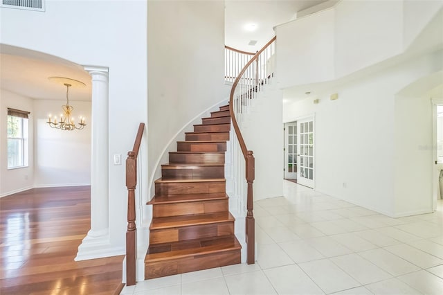 7716 Nottinghill Sky Dr, Apollo Beach, FL 33572 - staircase with a high ceiling, arched walkways, and a chandelier