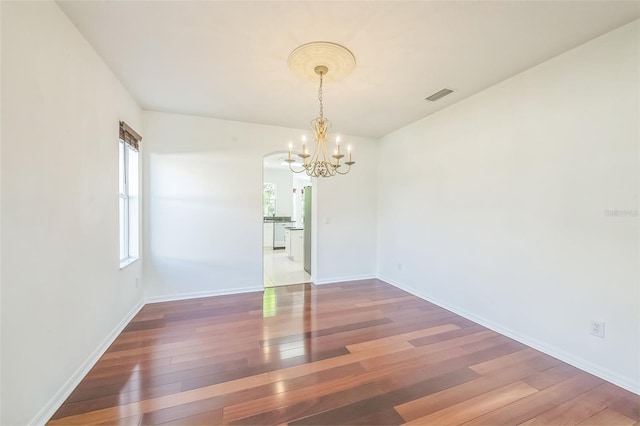 7716 Nottinghill Sky Dr, Apollo Beach, FL 33572 - unfurnished room with a chandelier and hardwood / wood-style floors