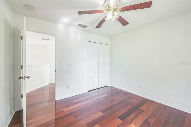 7716 Nottinghill Sky Dr, Apollo Beach, FL 33572 - unfurnished bedroom featuring wood finished floors, a closet, and a ceiling fan