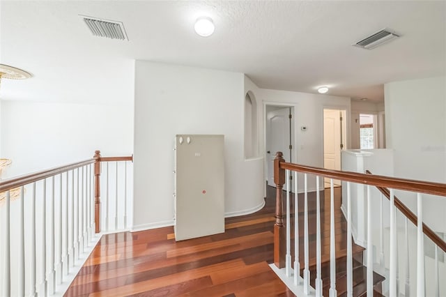 7716 Nottinghill Sky Dr, Apollo Beach, FL 33572 - corridor featuring wood finished floors and an upstairs landing