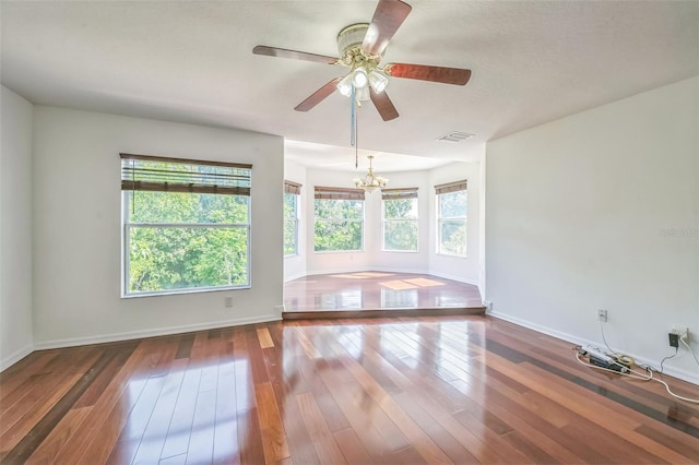 7716 Nottinghill Sky Dr, Apollo Beach, FL 33572 - unfurnished room featuring a chandelier, hardwood / wood-style flooring, and a ceiling fan