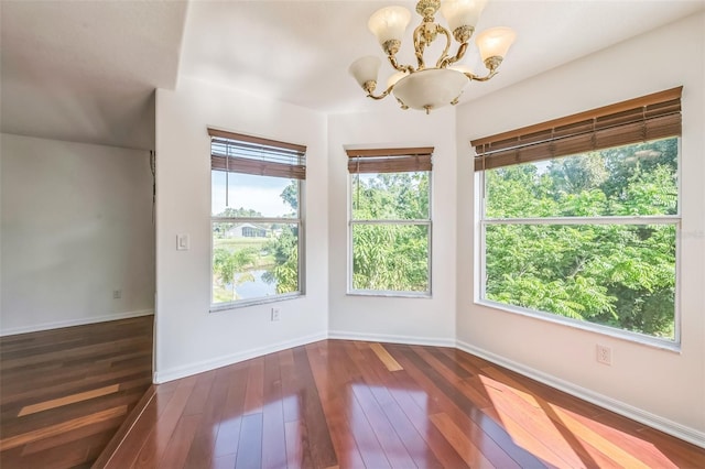 7716 Nottinghill Sky Dr, Apollo Beach, FL 33572 - spare room with a chandelier and hardwood / wood-style flooring