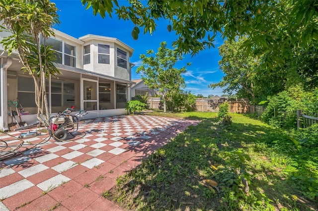 7716 Nottinghill Sky Dr, Apollo Beach, FL 33572 - fenced backyard featuring a sunroom and a patio area