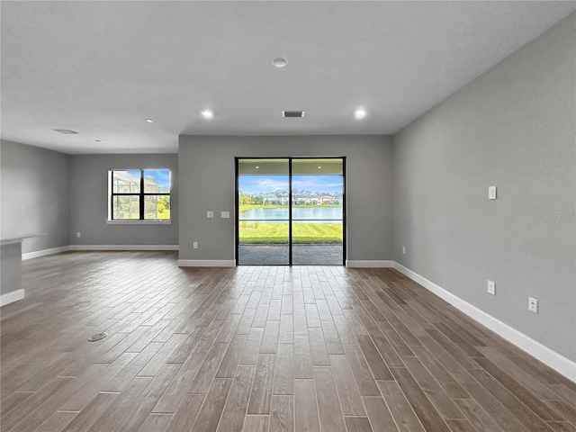 6256 Baywood Ct, Bradenton, FL 34211 - unfurnished room featuring wood finished floors and recessed lighting