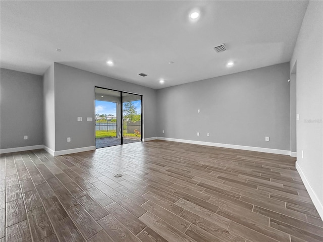 6256 Baywood Ct, Bradenton, FL 34211 - empty room with dark wood-style flooring and recessed lighting