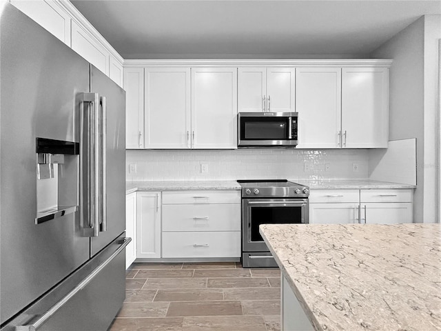 6256 Baywood Ct, Bradenton, FL 34211 - kitchen featuring stainless steel appliances, white cabinetry, and backsplash